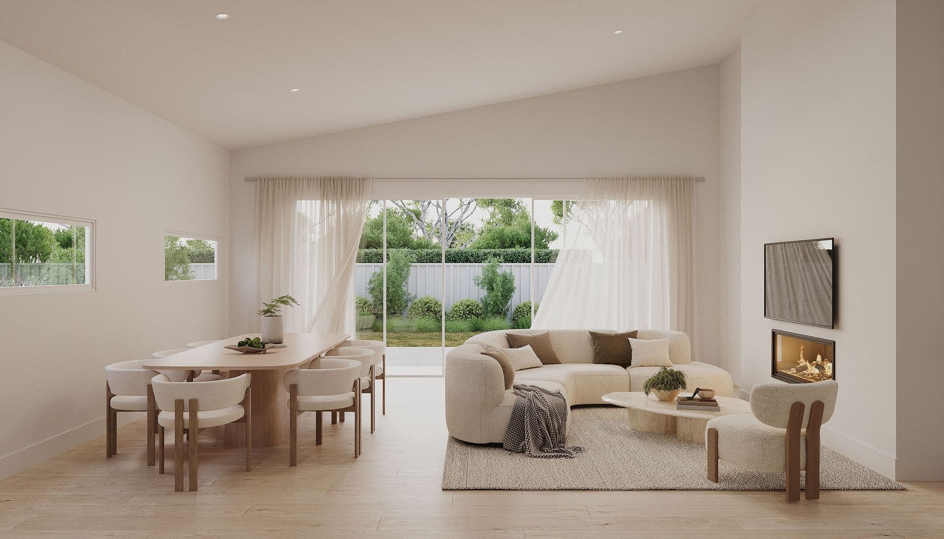 Open-plan living and dining area with a curved sofa, gas fireplace, timber dining table, and sliding doors opening to the rear garden